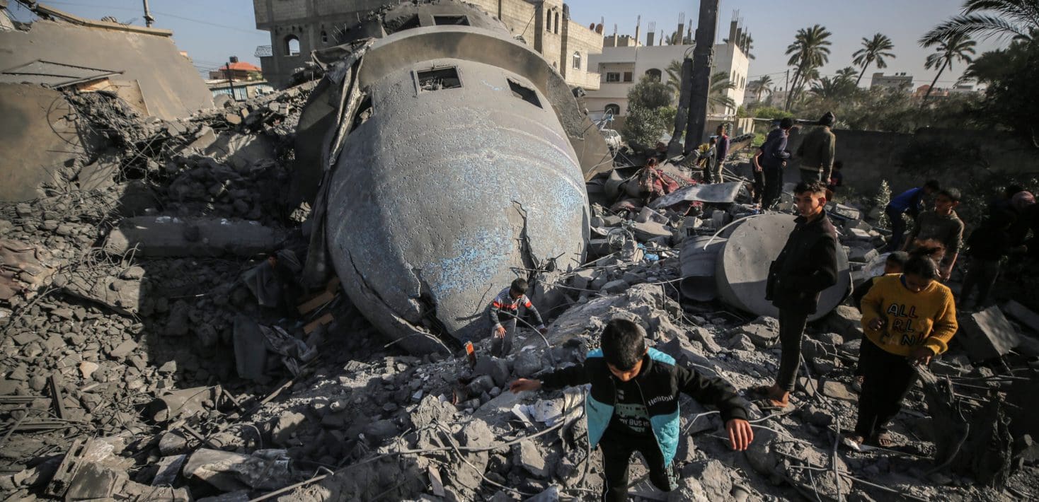 Palestinian children are walking past the rubble of the al-Bukhari mosque in Deir al-Balah, central Gaza Strip, on March 2, 2024, following an overnight Israeli air strike amid continuing battles between Israel and the Palestinian militant group Hamas.