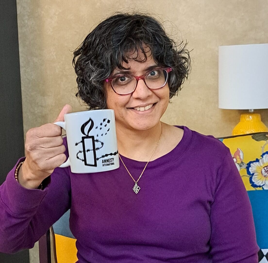 Sameena holding a coffee mug