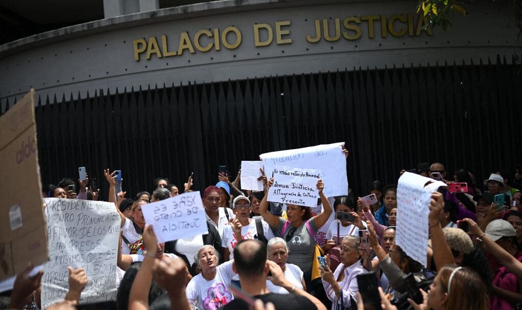 People participate in a demonstration to demand better conditions for their imprisoned relatives in front of the Palace of Justice in Caracas on June 12, 2024. Relatives of inmates protested Wednesday in Caracas in support of the hunger strike that has been underway since the weekend in some 19 Venezuelan prisons amid allegations of corruption, procedural delays, overcrowding, and limited access to food. (Photo by Federico PARRA / AFP) (Photo by FEDERICO PARRA/AFP via Getty Images)