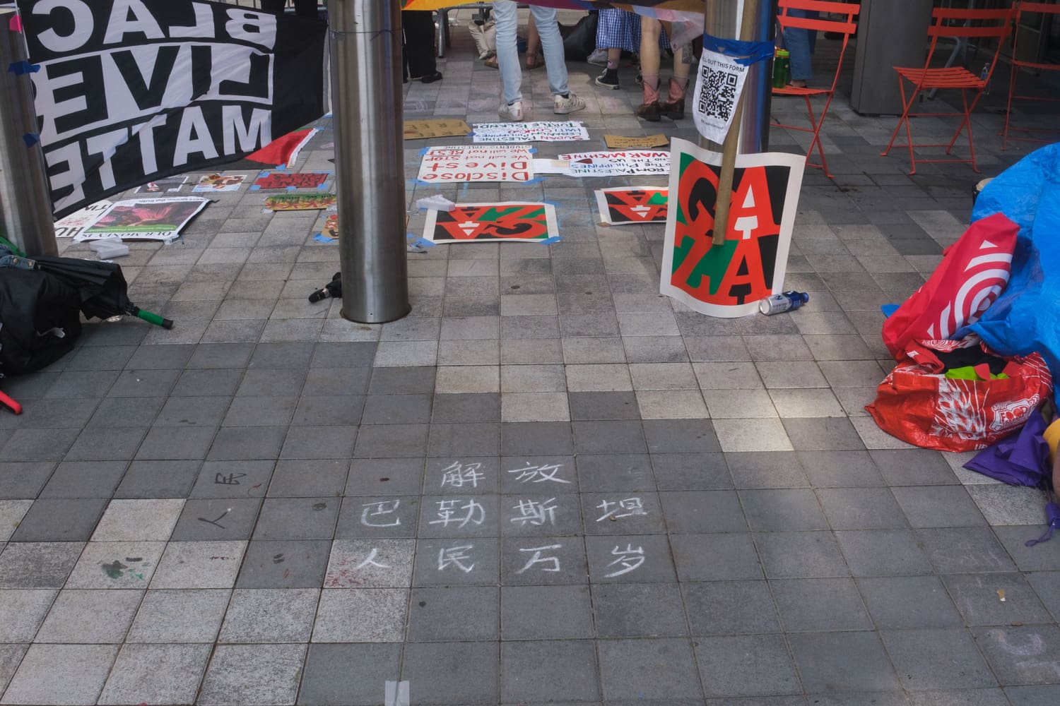 Liberate Palestine, long live the people” written on the sidewalk in Simplified Chinese at the pro-Palestinian encampment outside Paulson Center at New York University, April 30th 2024.