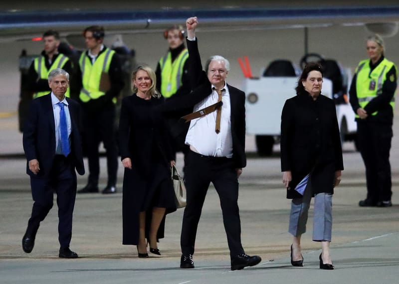 WikiLeaks founder Julian Assange gestures as he arrives at Canberra Airport on June 26, 2024 in Canberra, Australia, as a free man.
