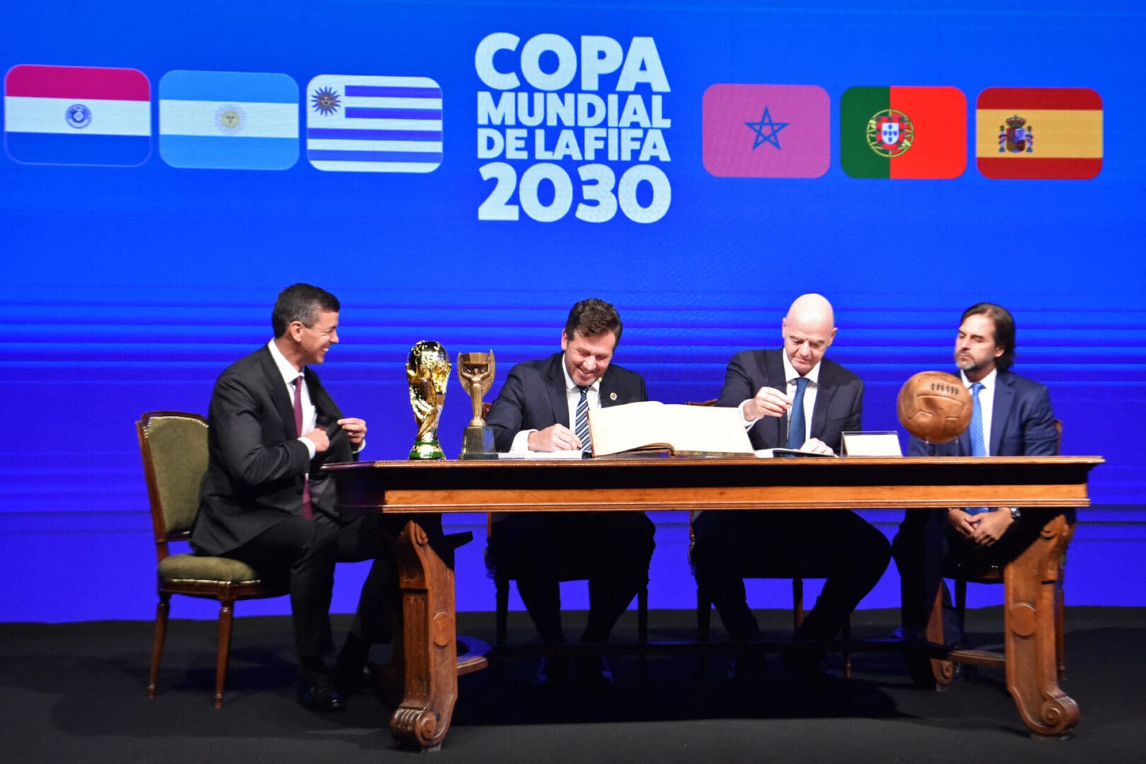 Conmebol's President Alejandro Dominguez (L-2) and FIFA President Gianni Infantino (R-2), accompanied by Paraguay's President Santiago PeÃ±a (L) and Uruguay's President Luis Lacalle(R), sign a book of minutes of the 2030 World Cup during Conmebol's 78th Ordinary Congress in Luque, Paraguay on April 11, 2024.