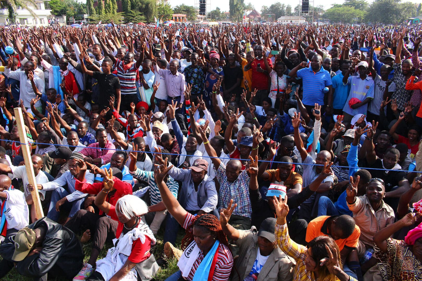 Supporters of Tanzania's main opposition party Chadema gesture during the party's first political rally after an imposed ban from 2016 was lifted, at Furahisha Grounds in Mwanza, on January 21, 2023.