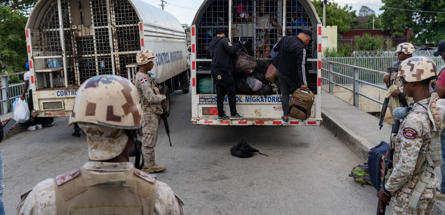 migration control trucks in Dominican Republic along with soldiers.