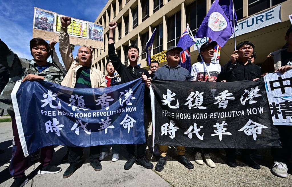 People gather to protest against Hong Kong's new national security law outside the Chinese consulate in Los Angeles on March 23, 2024. Hong Kong's new national security law came into force on March 23, putting into immediate effect tough penalties of up to life imprisonment for crimes including treason and insurrection. The law -- commonly referred to as Article 23 -- will target five categories of national security crimes, and was swiftly passed by Hong Kong's opposition-free legislature on Tuesday. (Photo by Frederic J. BROWN / AFP) (Photo by FREDERIC J. BROWN/AFP via Getty Images)